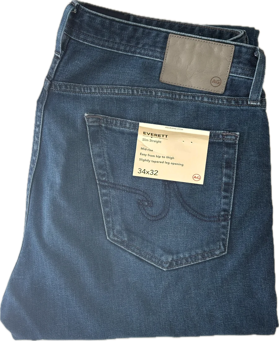 Folded AG jeans with their Everett tag on the back pocket: Slim Straight, 34x32.
